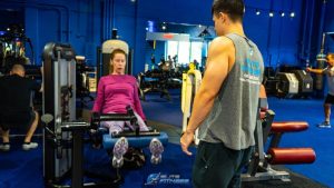 personal trainer teaching someone how to workout.